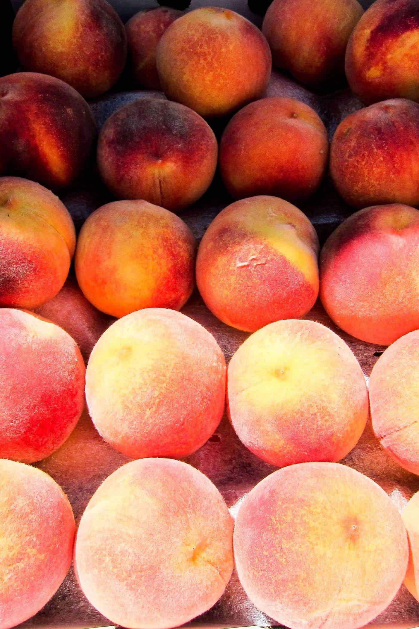 peaches stacked in rows.