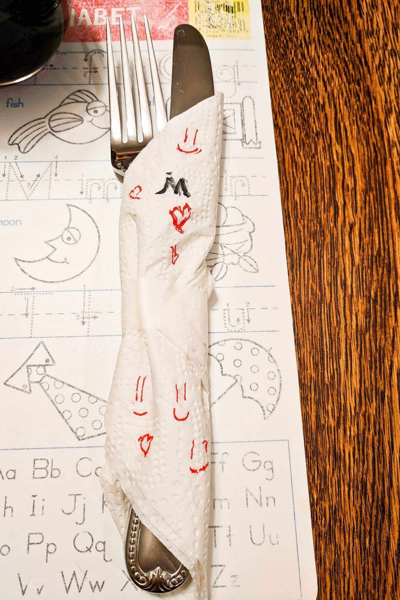 kid-decorated napkin on placemat.