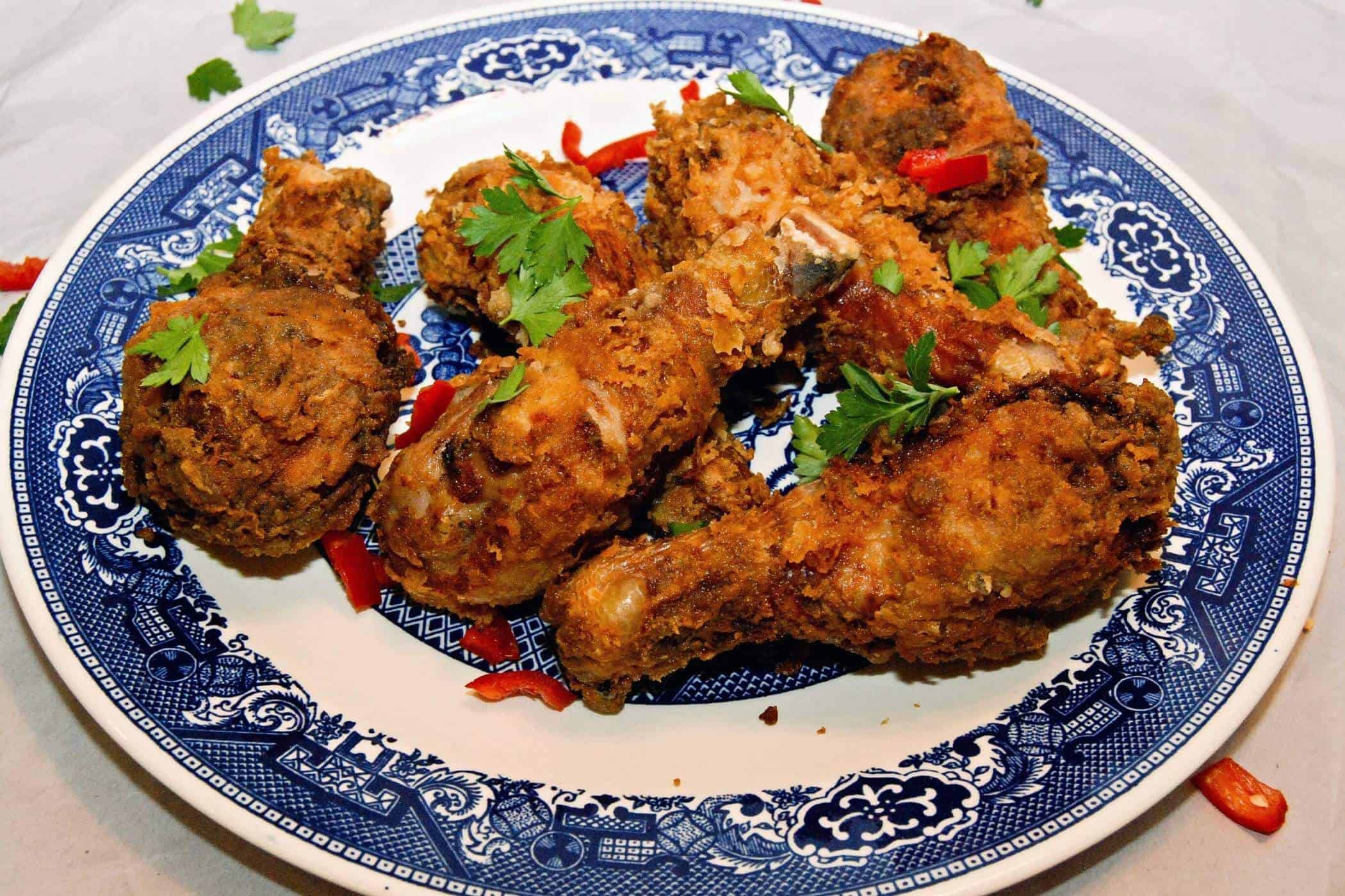 spicy fried chicken drumsticks on plate.