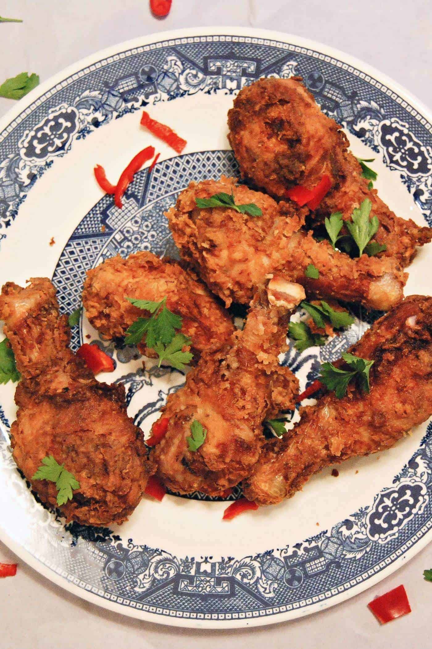 spicy fried chicken drumsticks on plate.