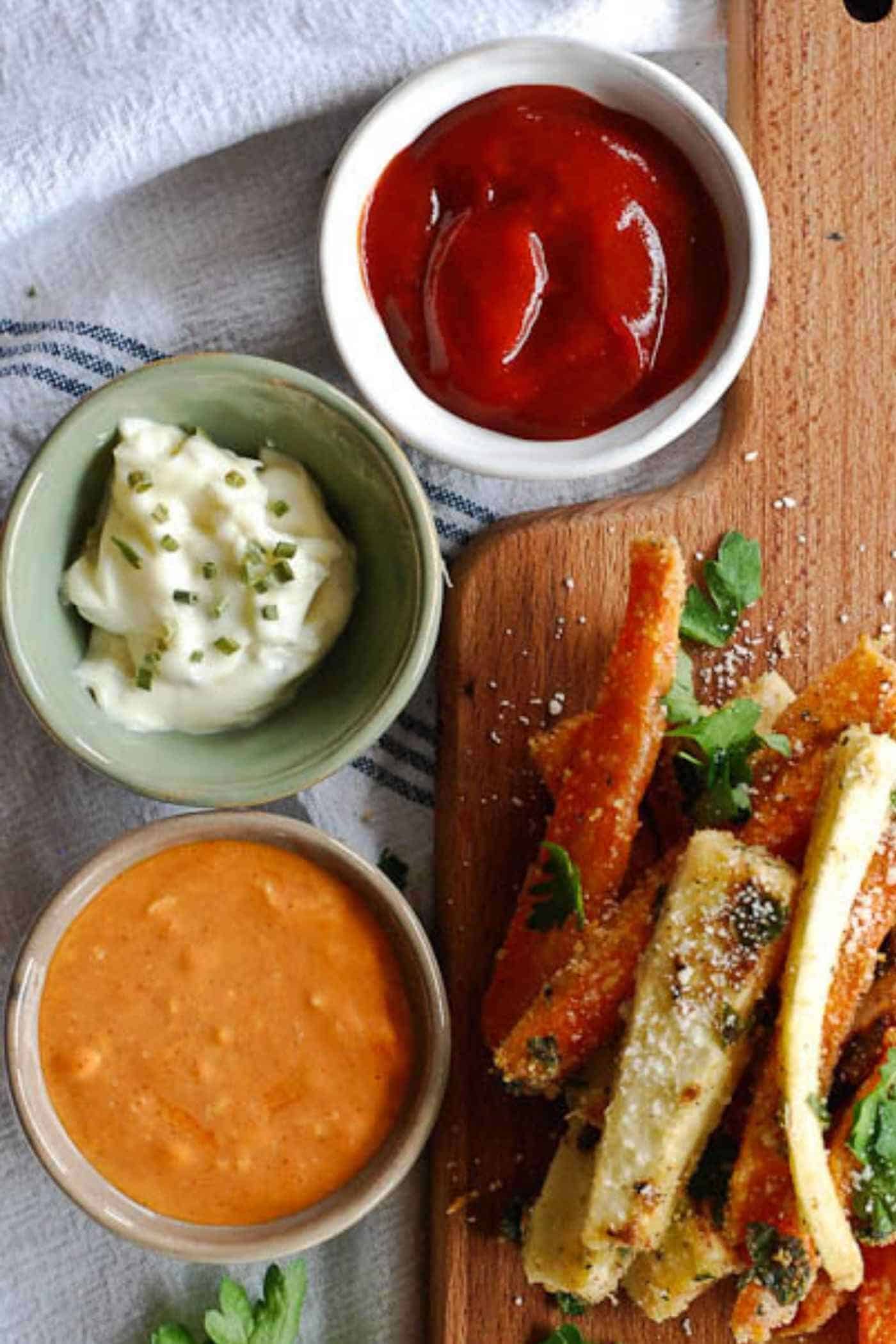 sauces for veggie fries - 3 varieties in bowls, next to veggie fries: garlic mayo, sriracha mayo and ketchup sriracha.