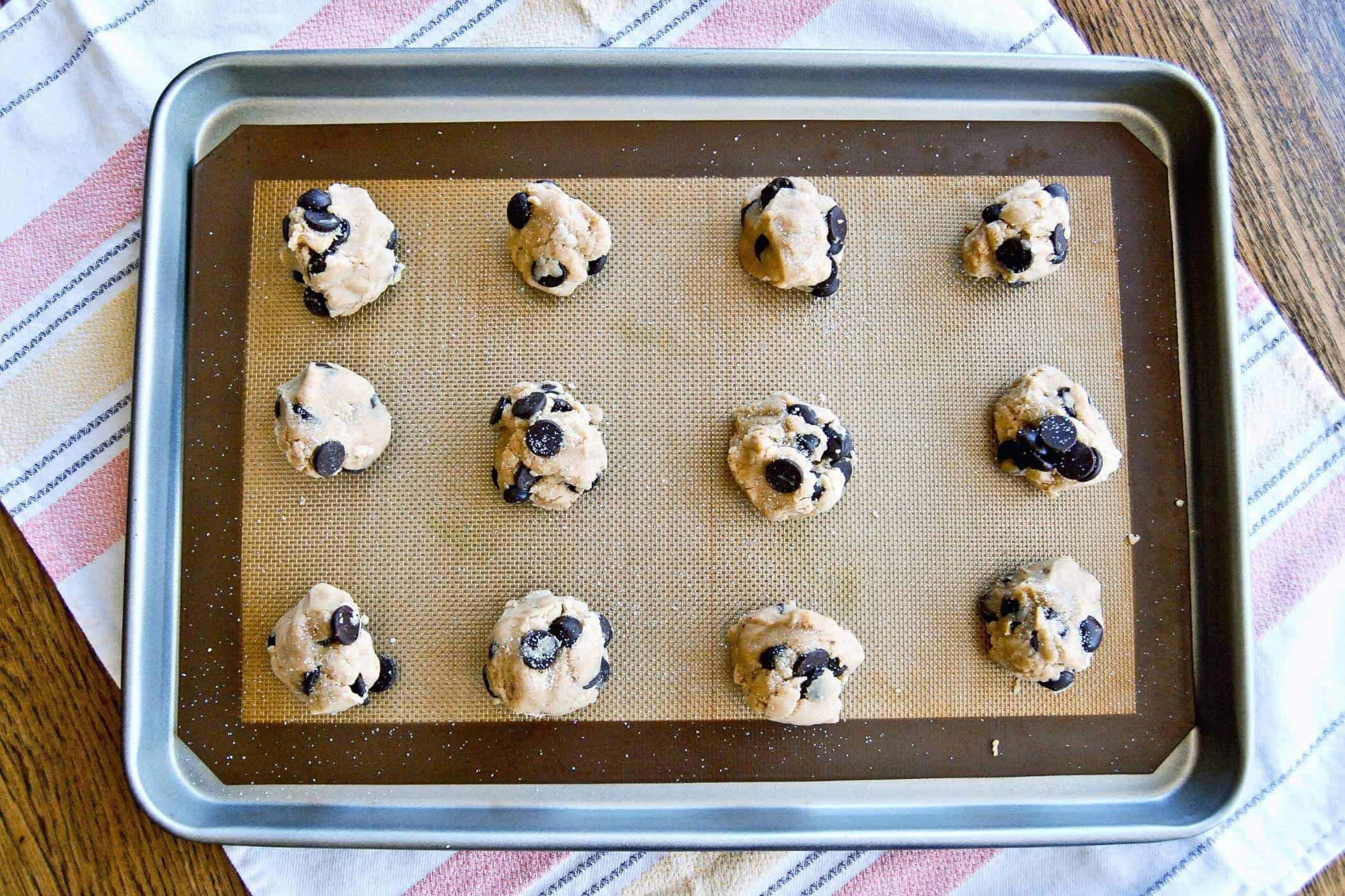 chocolate chip cookie dough balls on baking tray.