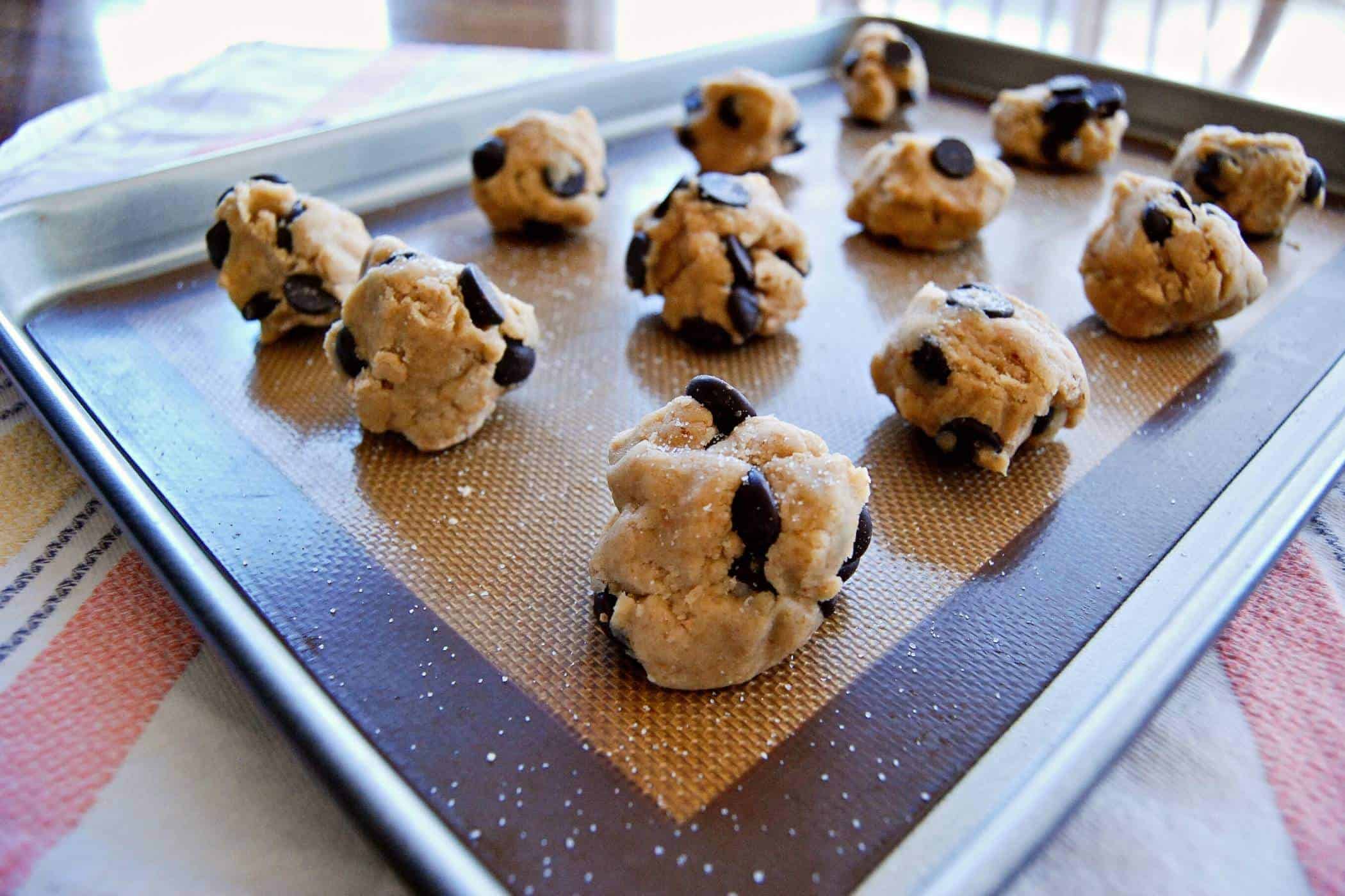 chocolate chip cookie dough balls on baking tray.