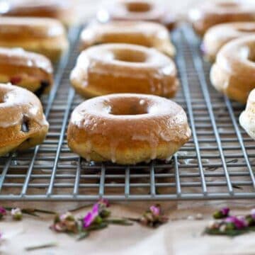 glazed cake donuts on cooling rack.