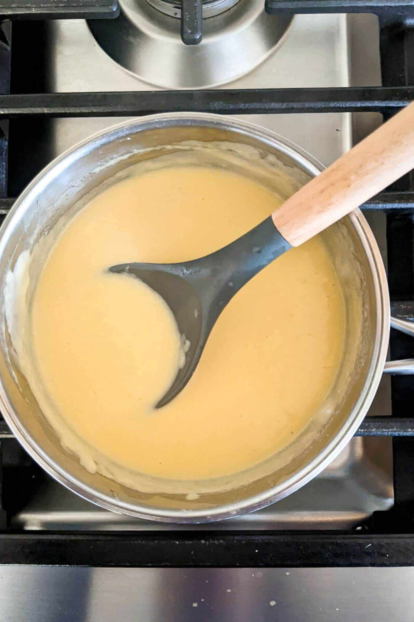 cheese sauce in pot on stove.