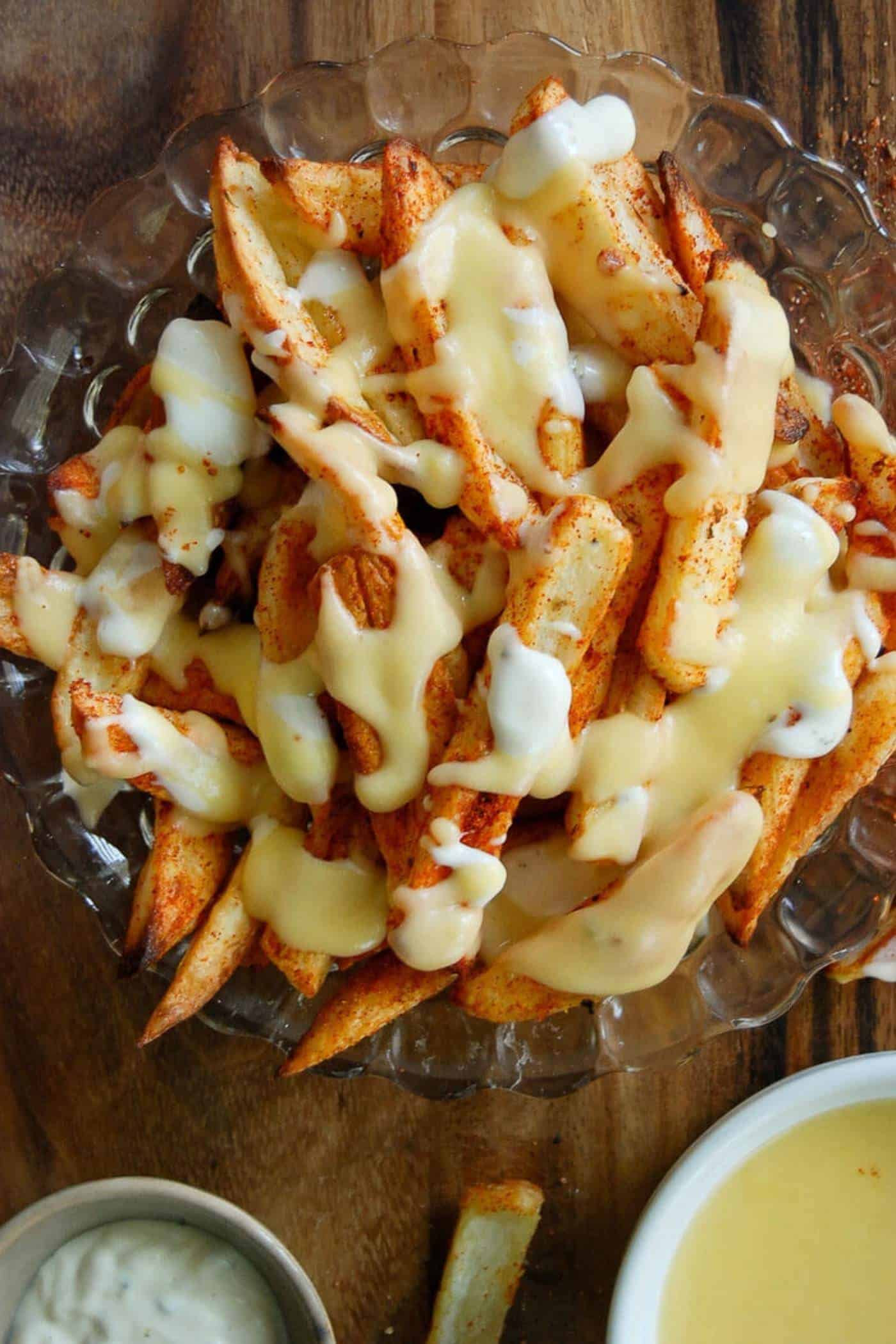 louisiana voodoo fries with cajun seasoning ranch dressing and cheese sauce.