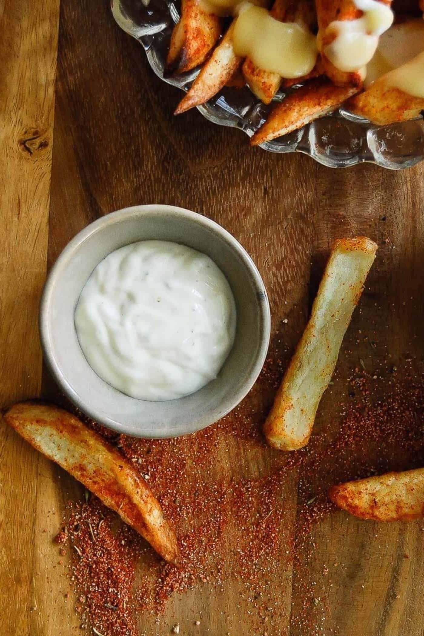 ranch dressing in bowl for dipping with fries next to it.