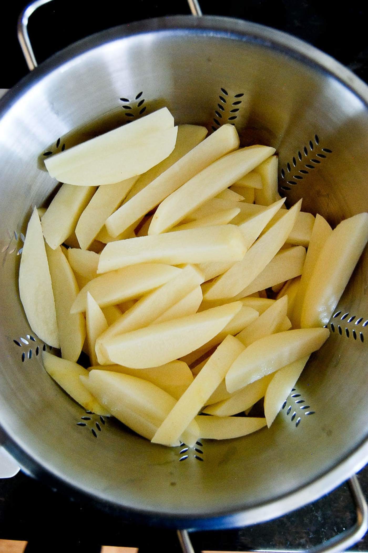cut potato fries in colander.