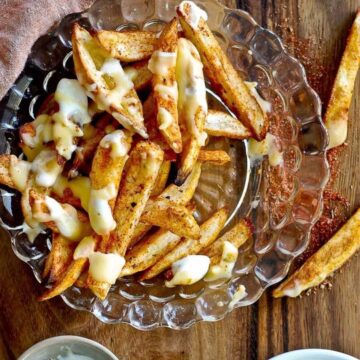 louisiana voodoo fries with cajun seasoning, ranch dressing and cheese sauce.