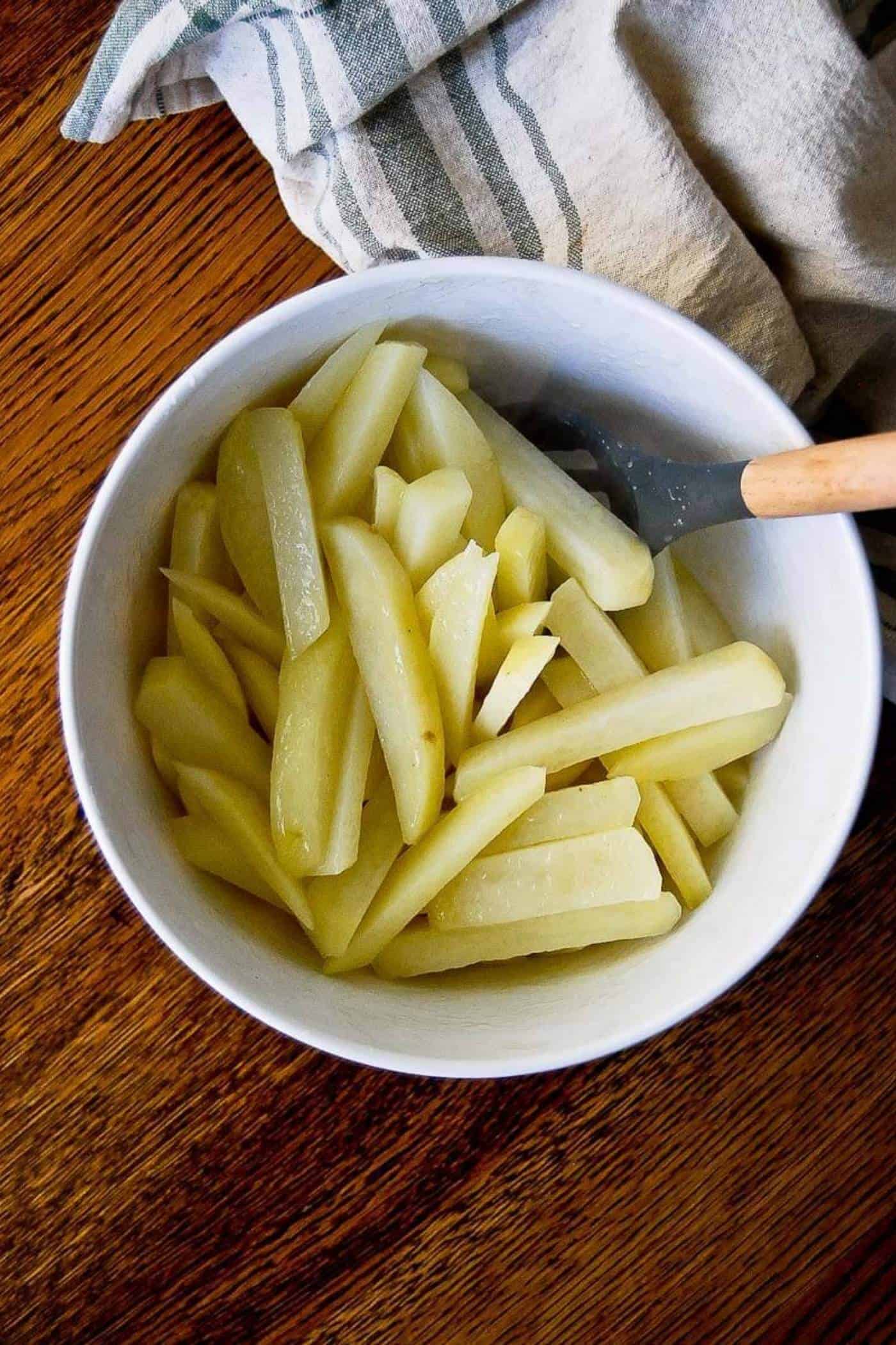 oiled fries in bowl, pre-bake.
