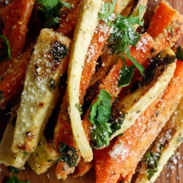 carrot and parsnip fries mixed with parmesan and herbs in bowl