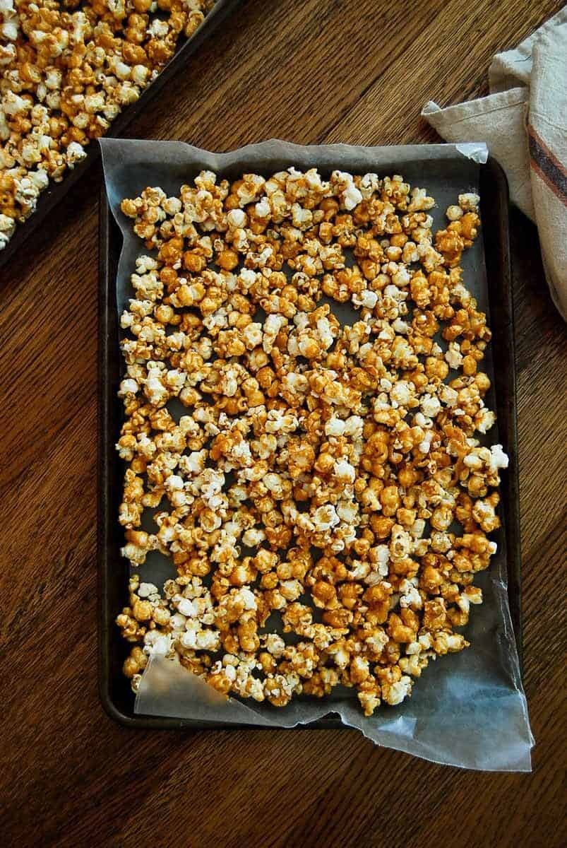 spicy caramel popcorn cooling on tray.