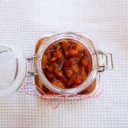 spicy peach chutney in a jar top down view.