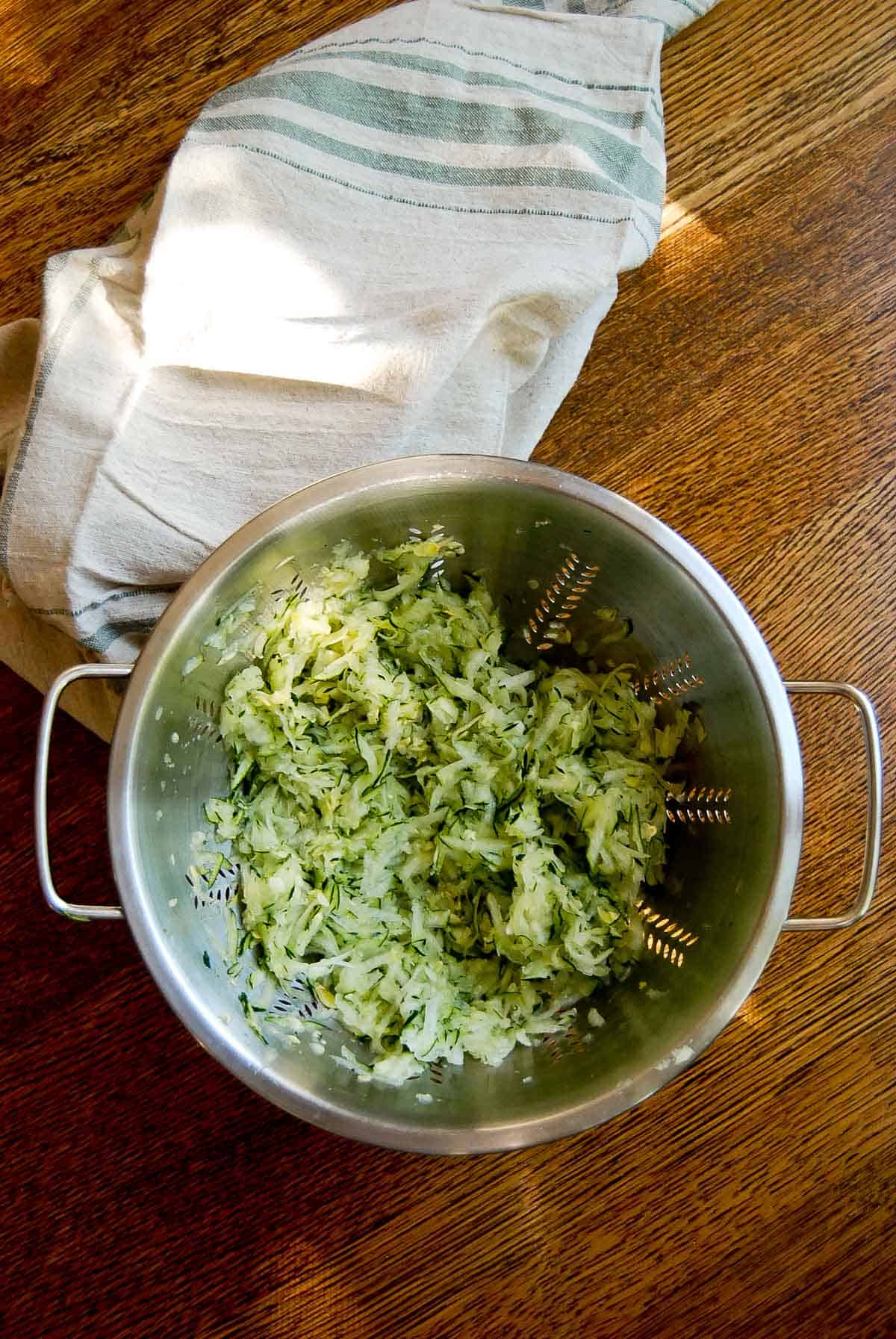 shredded zucchini in colander