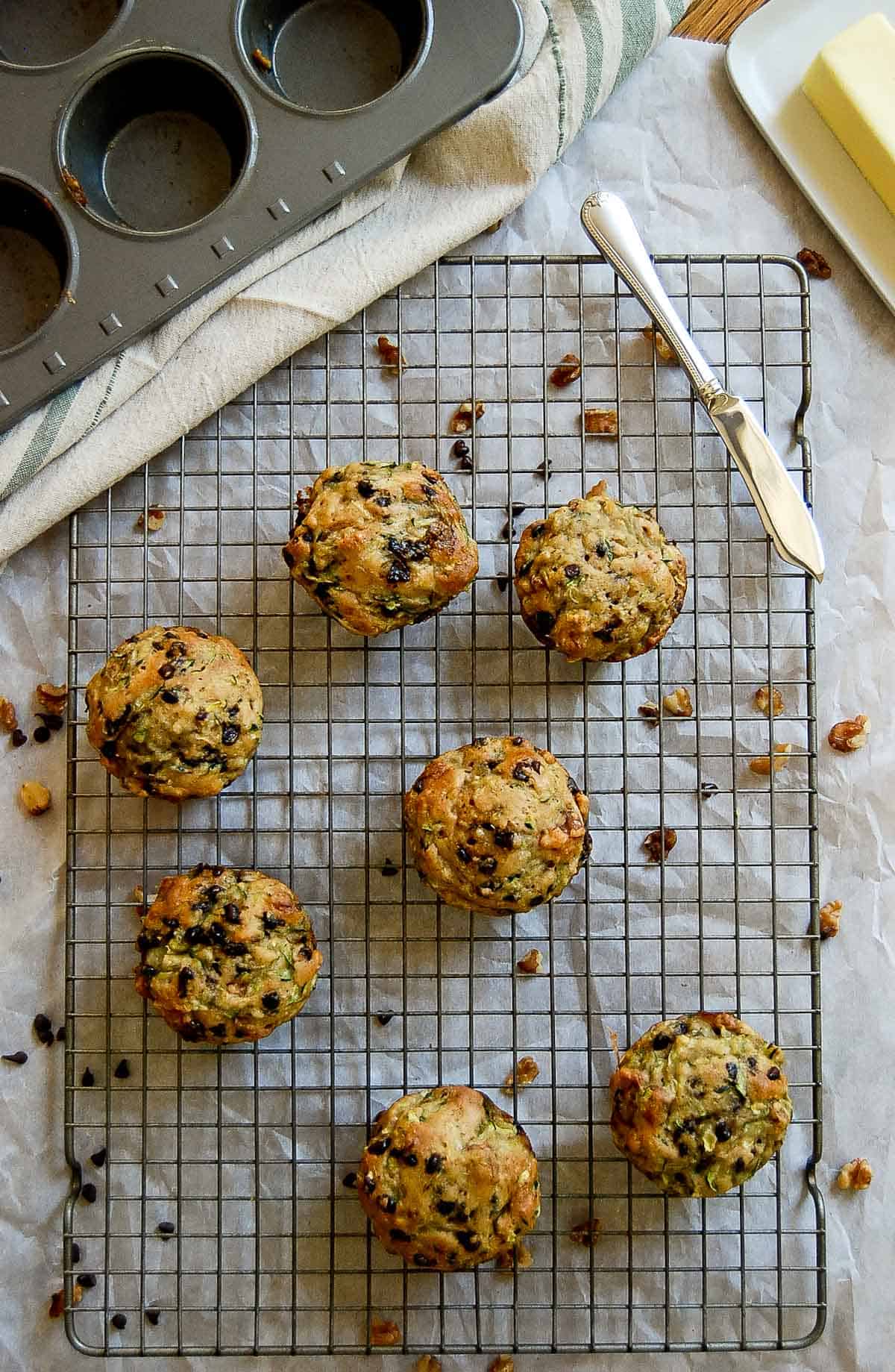 zucchini muffins with chocolate chips on cooling rack