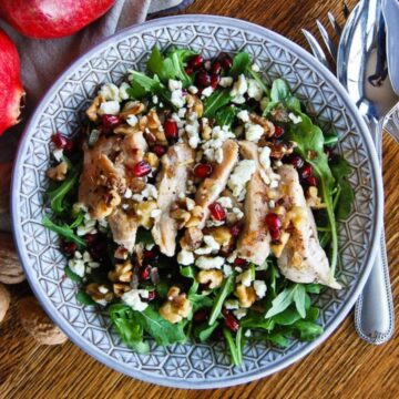 chicken pomegranate and arugula crunch salad in bowl.