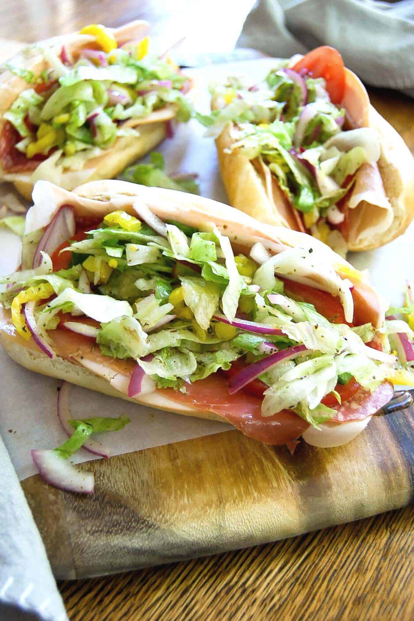 closeup of grinder sandwiches on board.