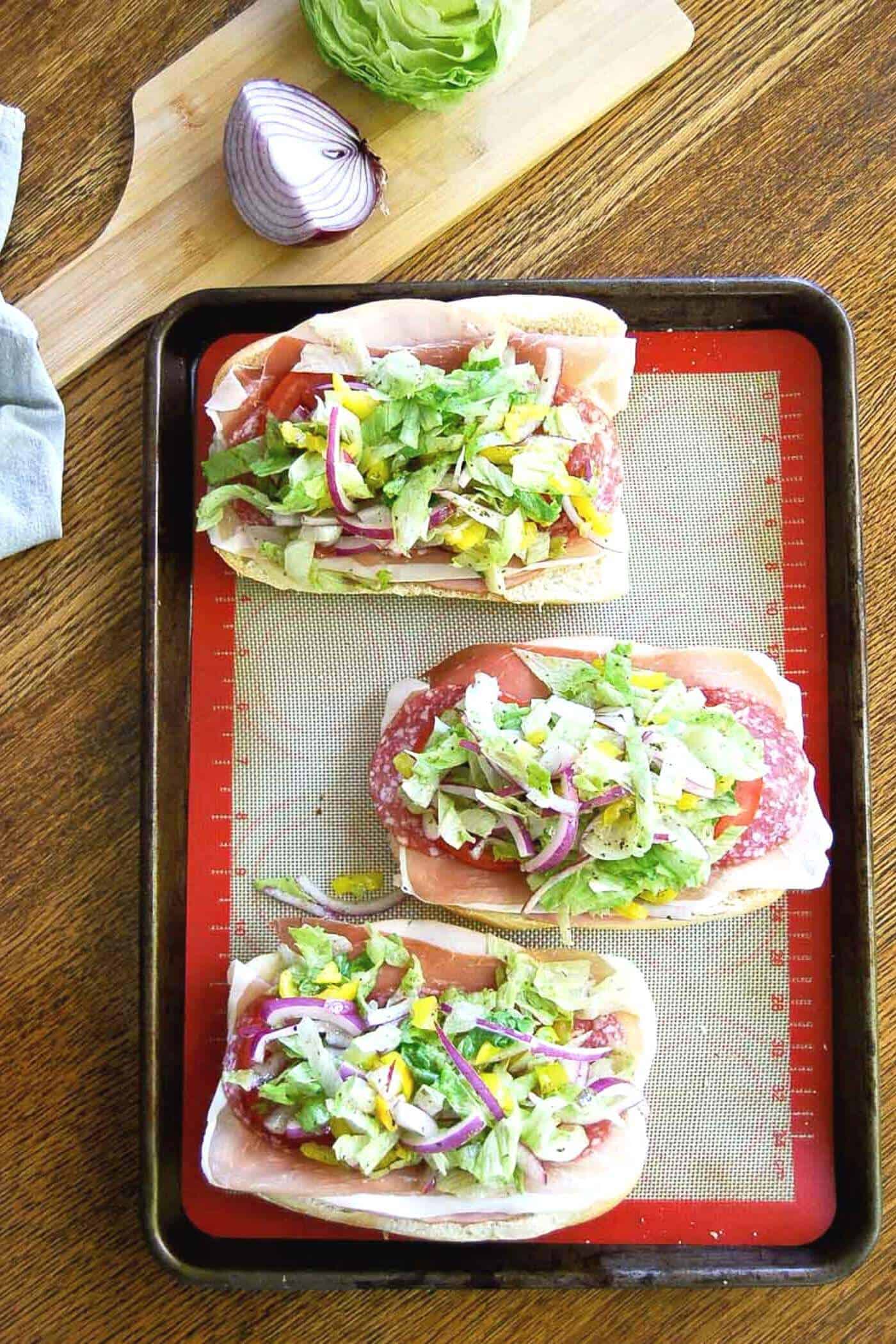 grinder sandwiches with grinder salad on tray