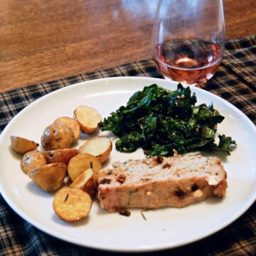 turkey meatloaf on plate with potatoes and spinach.