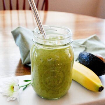 avocado pineapple smoothie in mason jar with straw