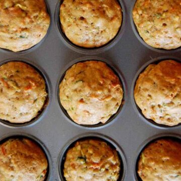 zucchini muffins with carrots in pan.