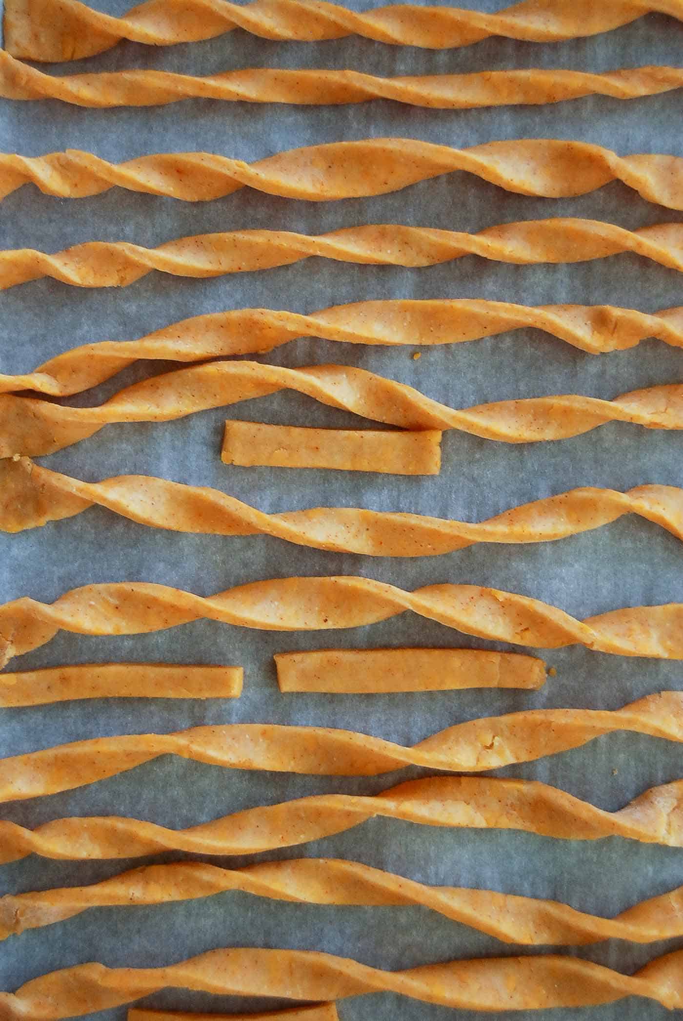 cheddar cheese straws on baking sheet ready to bake.