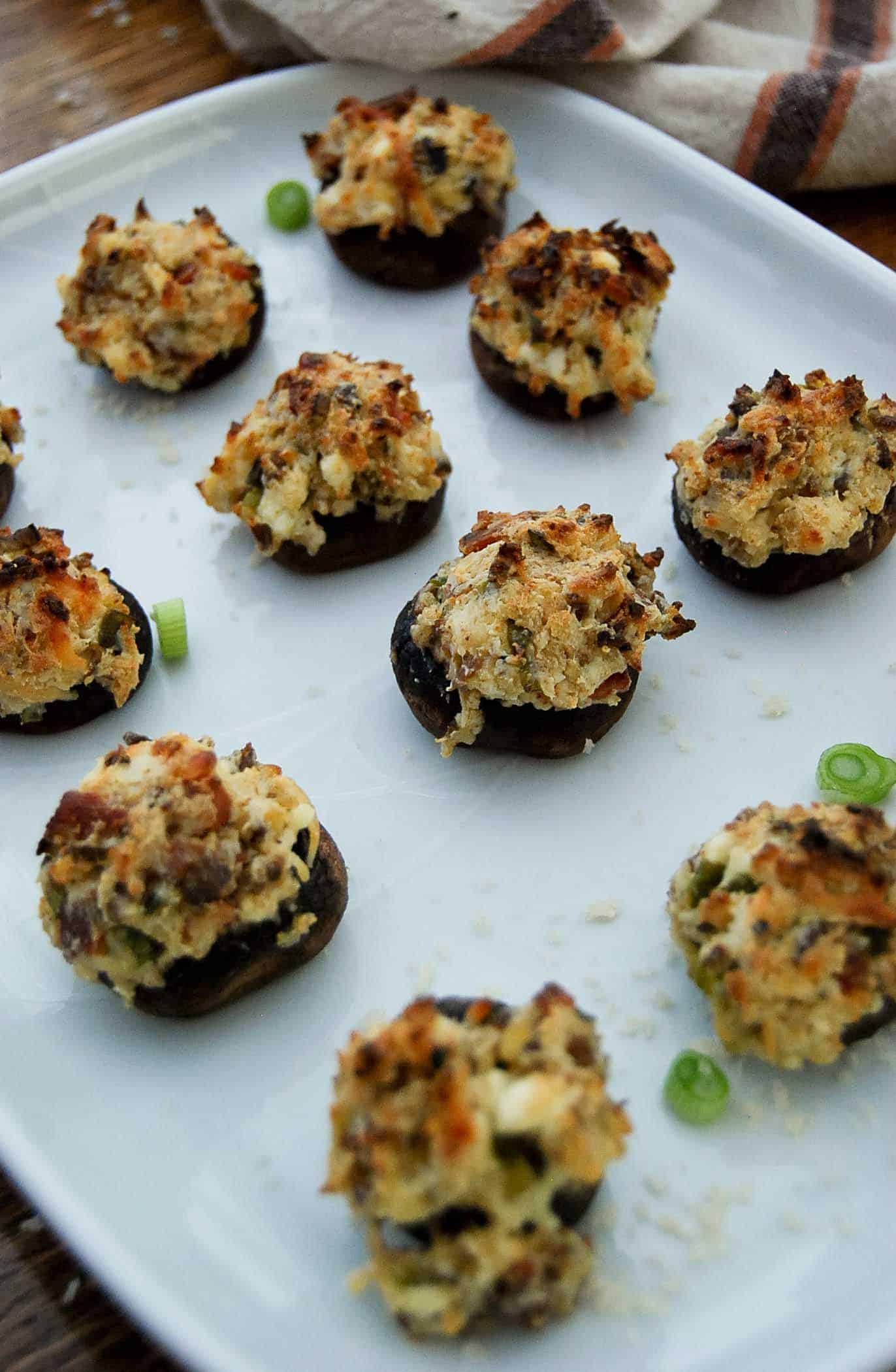 baked cream cheese stuffed mushrooms on serving tray.