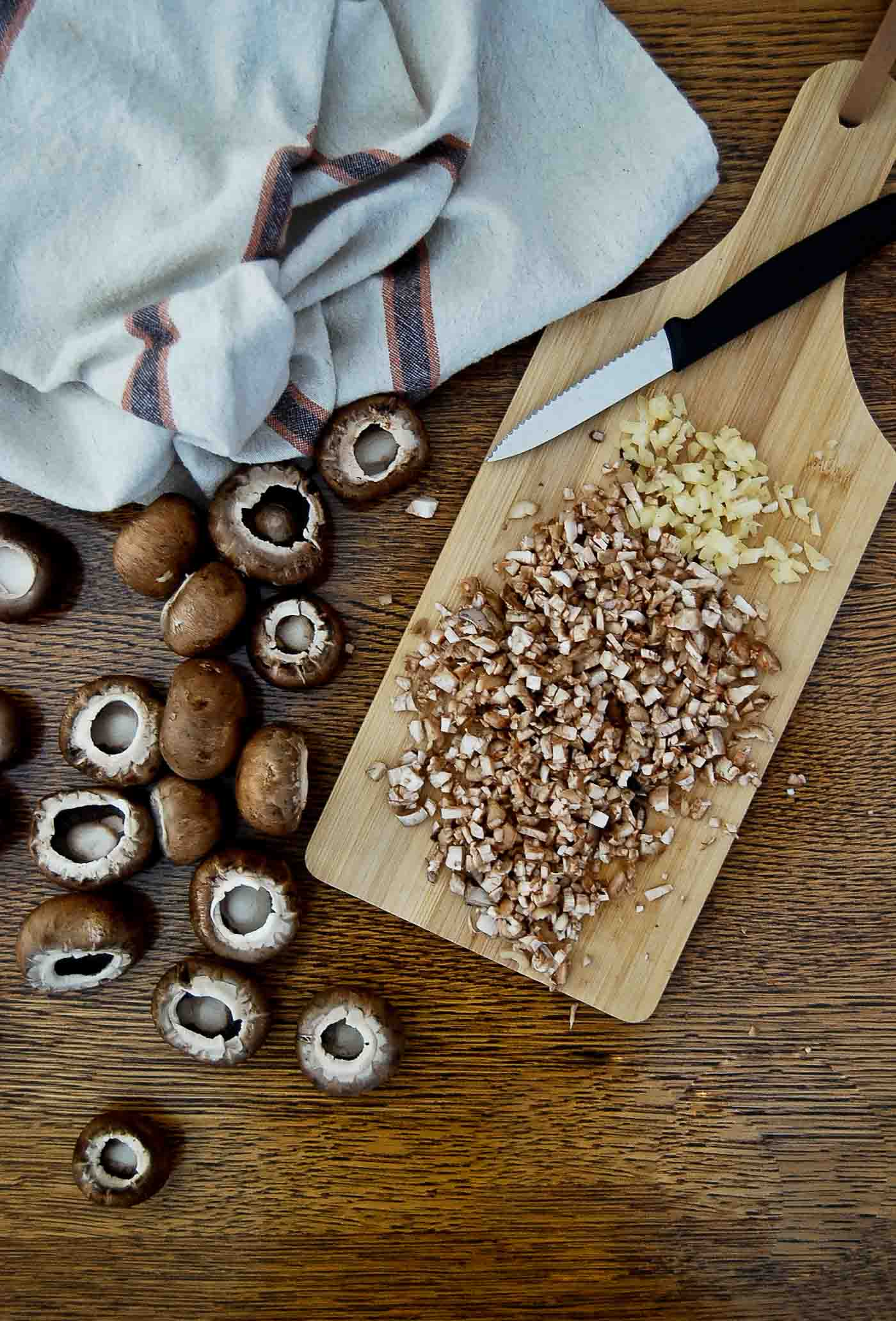 chopped mushrooms and garlic on cutting board.