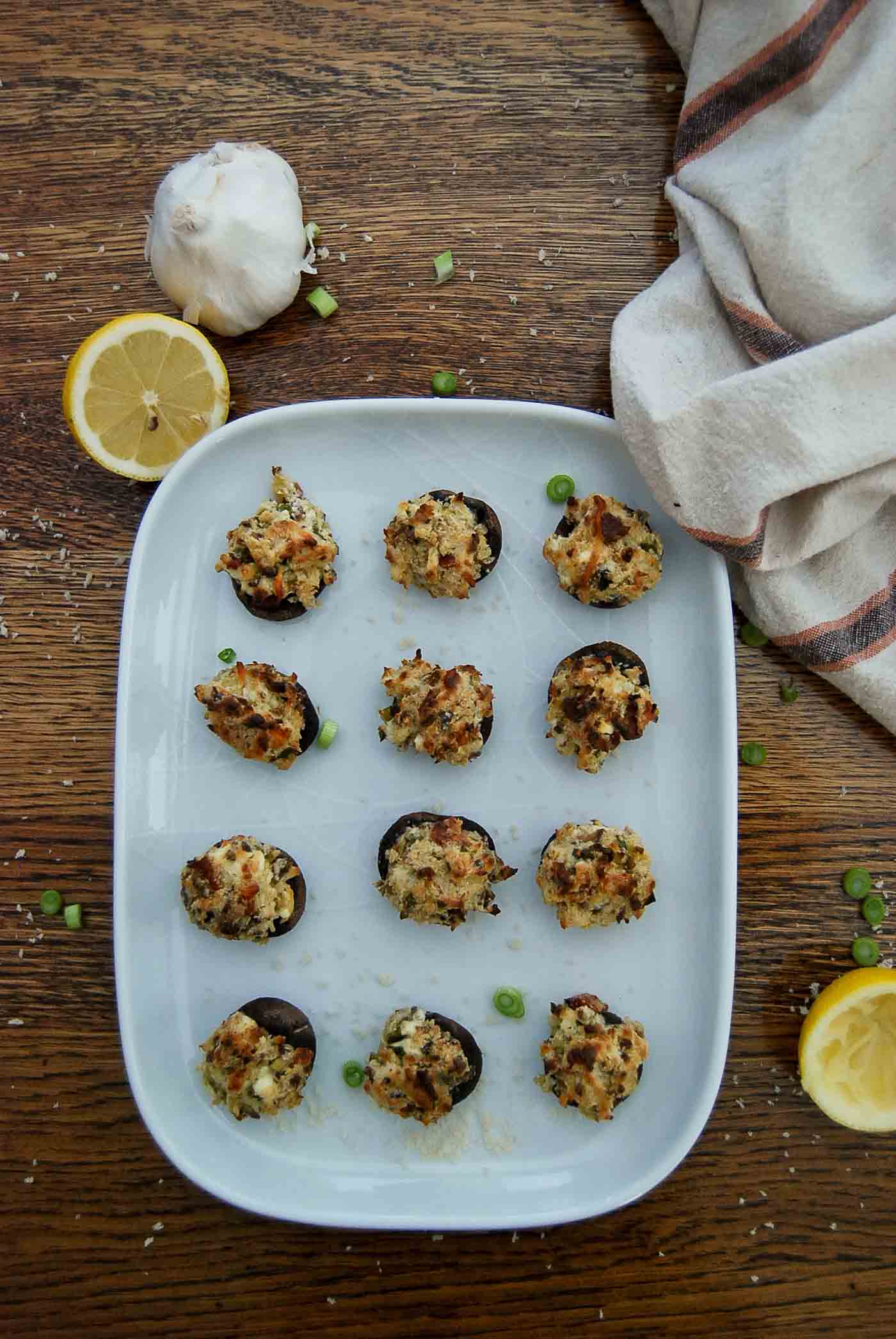 baked cream cheese stuffed mushrooms on serving tray.