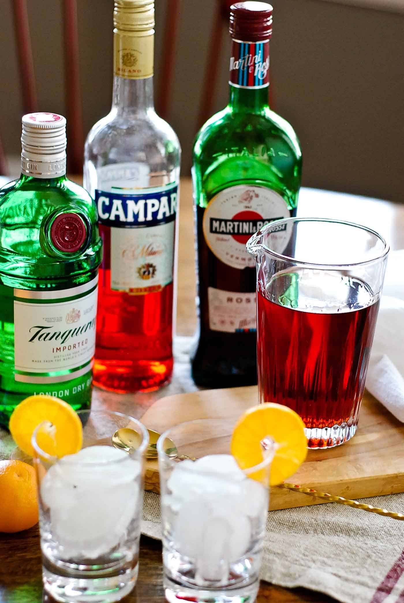 mixed negroni with ingredients and glasses.