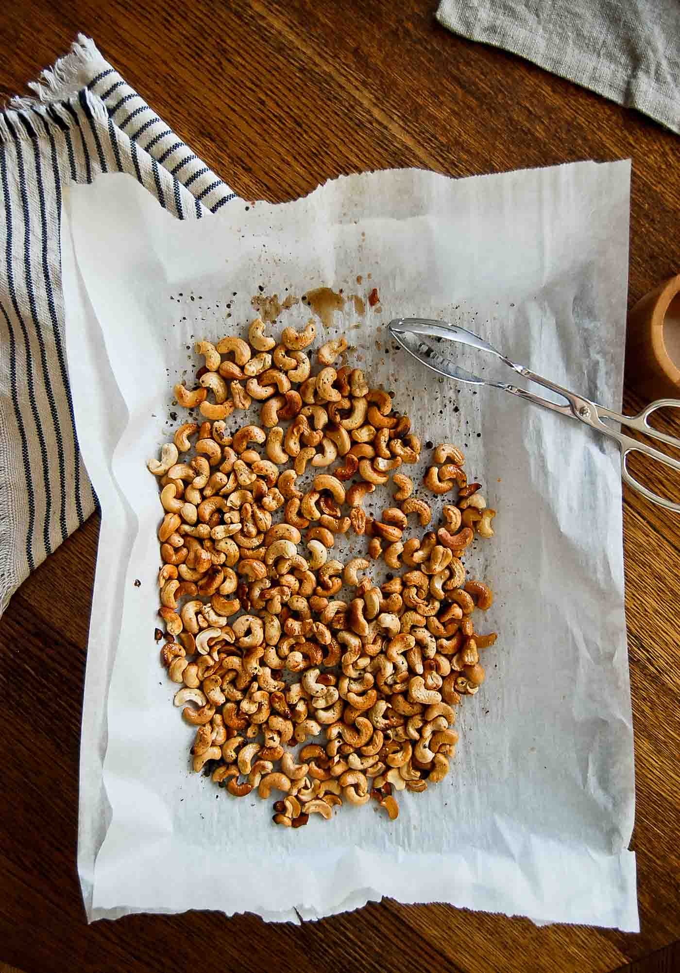 baking sheet with roasted cashews, salt and pepper.