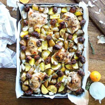 sheet pan chicken thighs, with sausage, potatoes and onions.