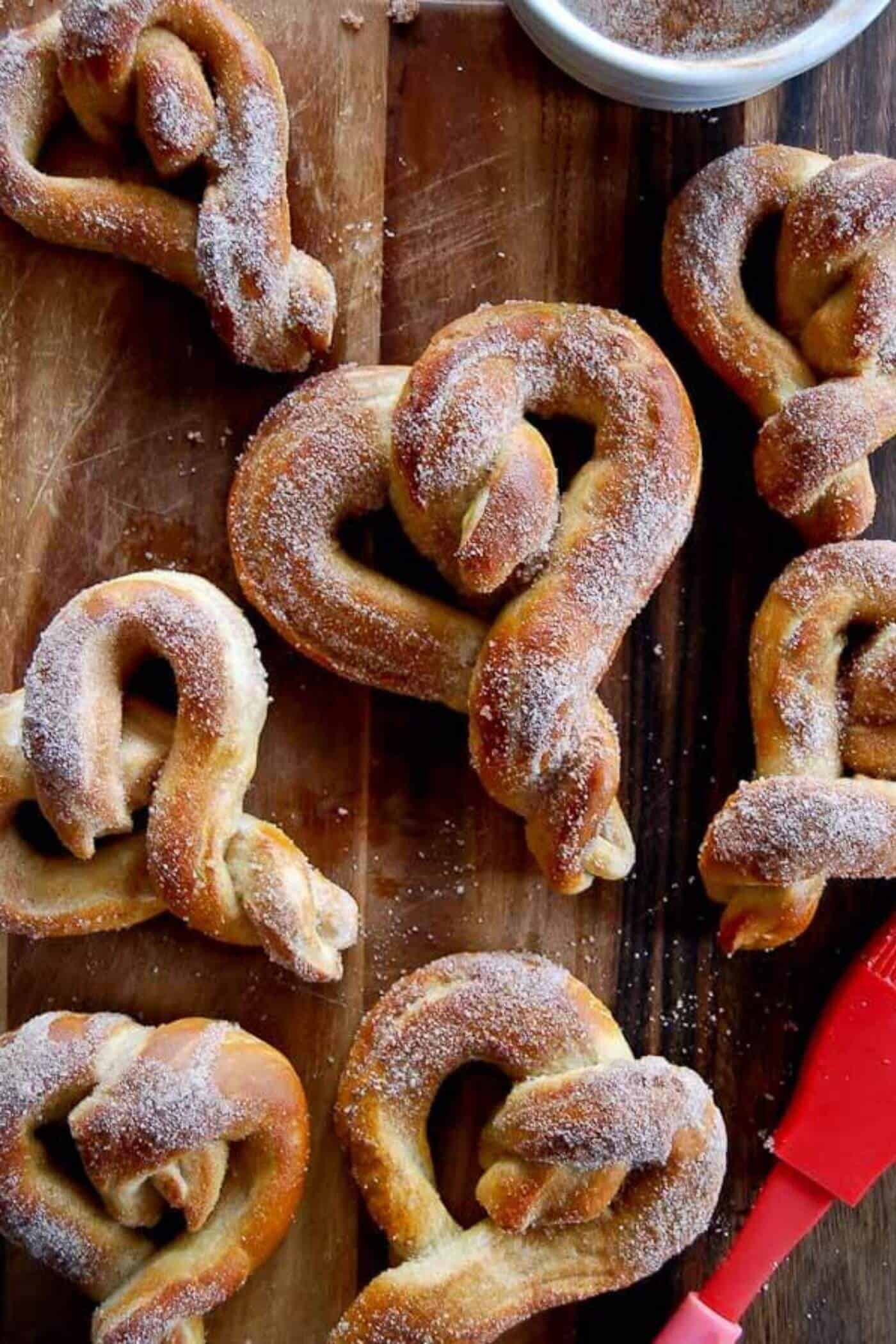 soft cinnamon sugar pretzels on cutting board.