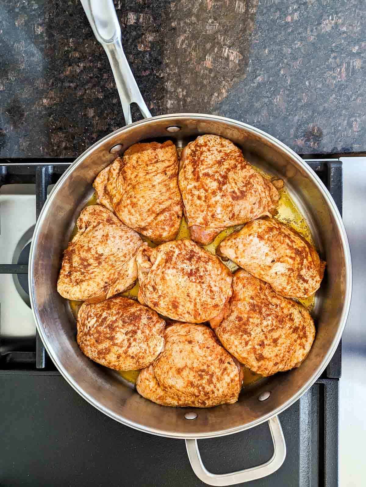 Turmeric Chicken searing in pan on stovetop.