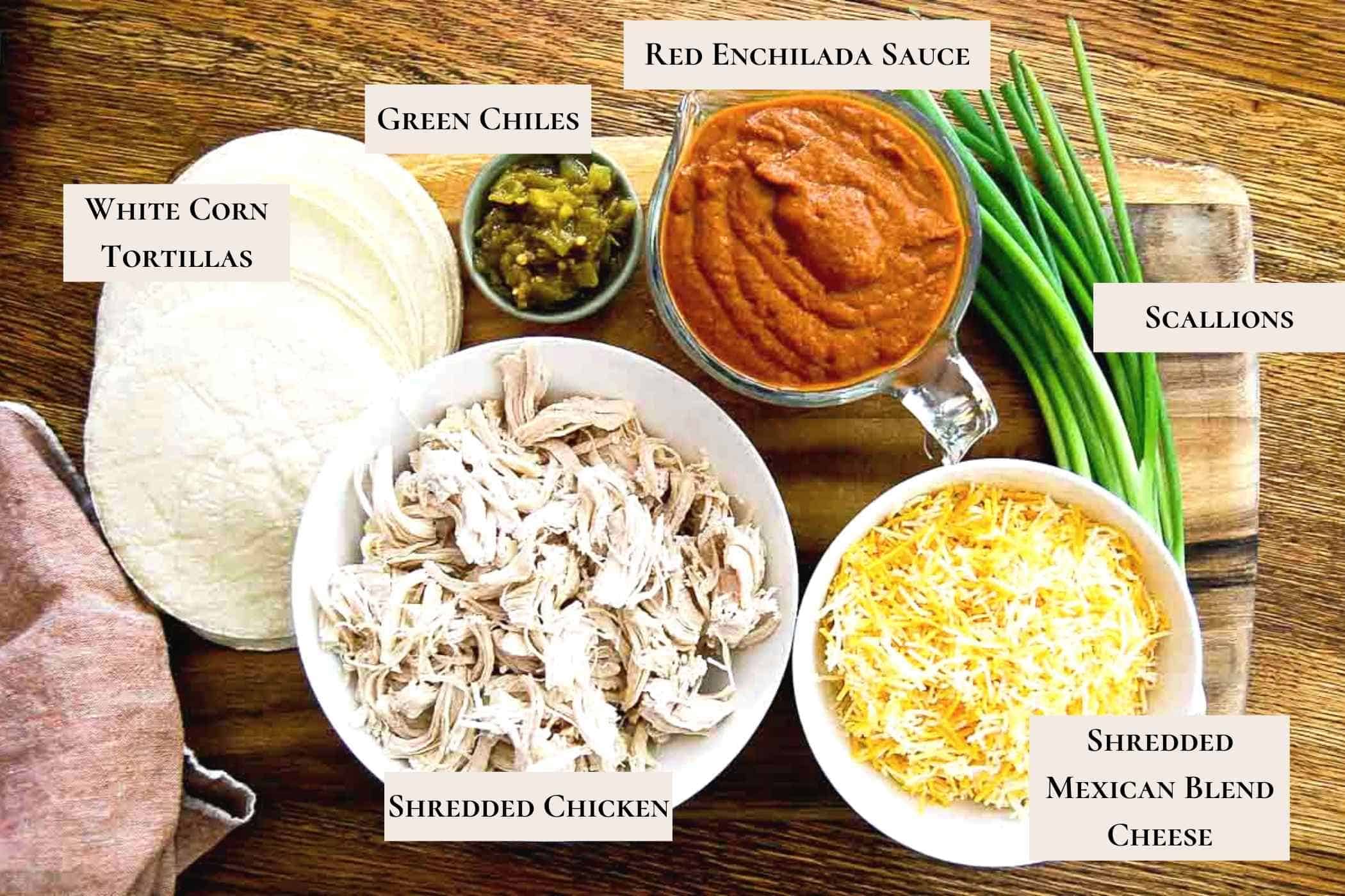 ingredients for red chicken enchiladas on cutting board.