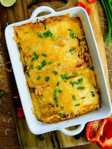 baked cheesy chicken enchiladas in baking dish.