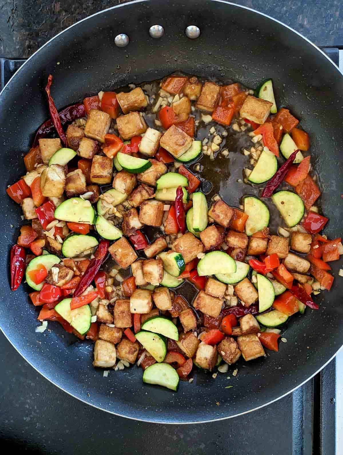kung pao tofu cooking in pan.