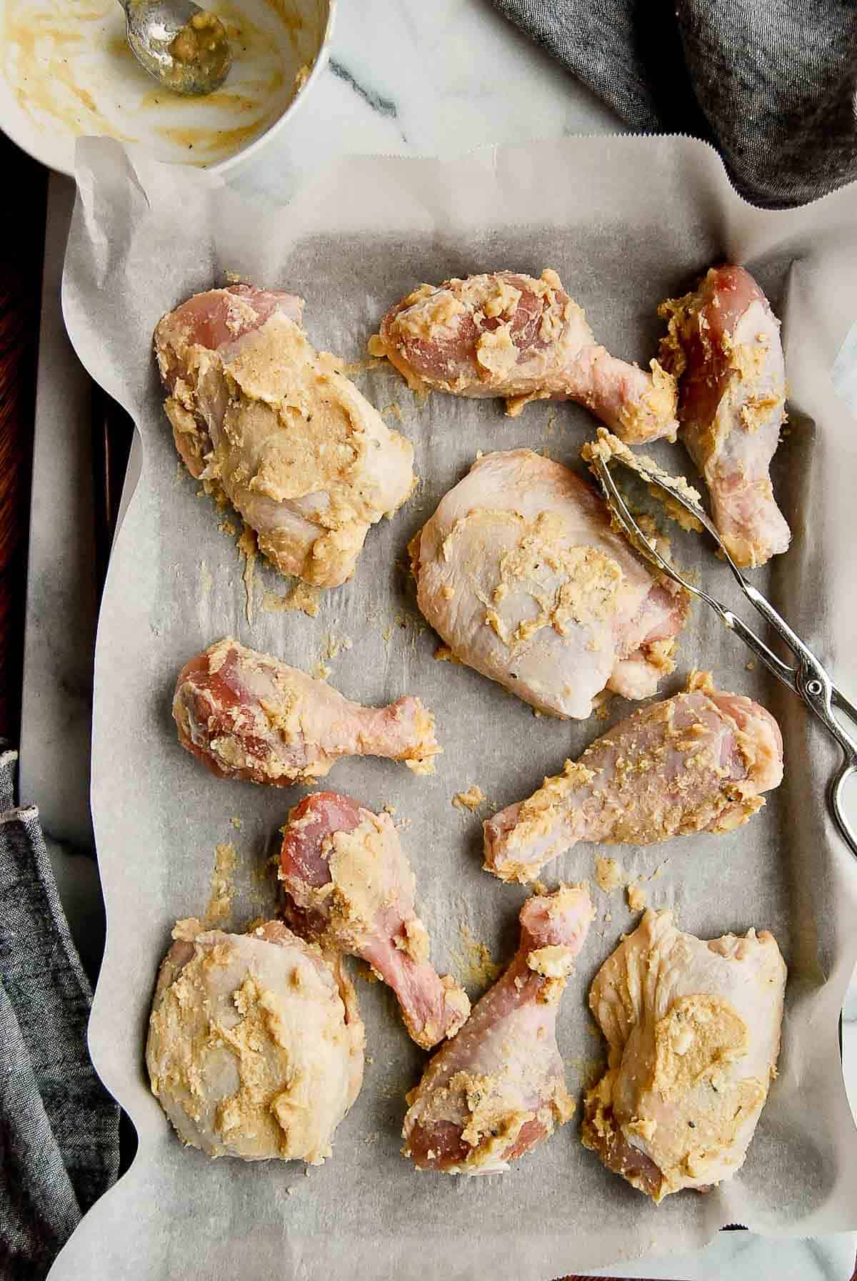 chicken thighs and drumsticks coated with miso honey paste on pan.