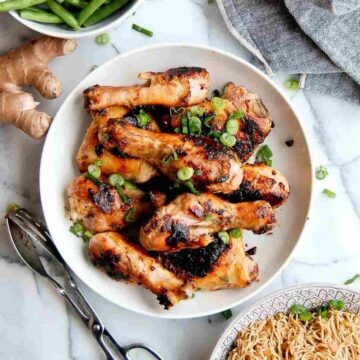 miso chicken in bowl with ginger knob in background.