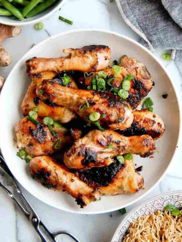 miso chicken in bowl with ginger knob in background.