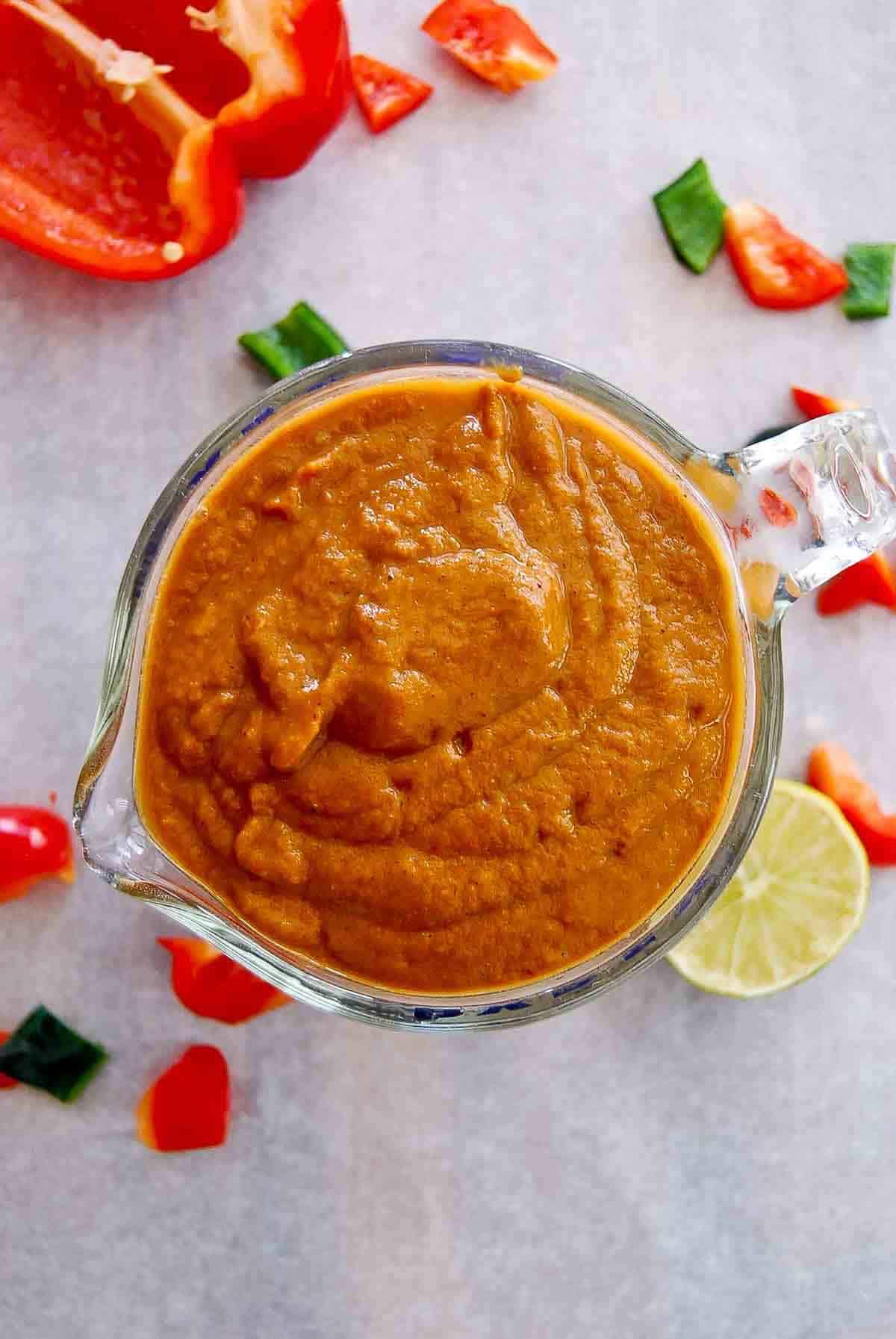 homemade red enchilada sauce in measuring cup.