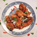 spicy fried chicken drumsticks on plate.