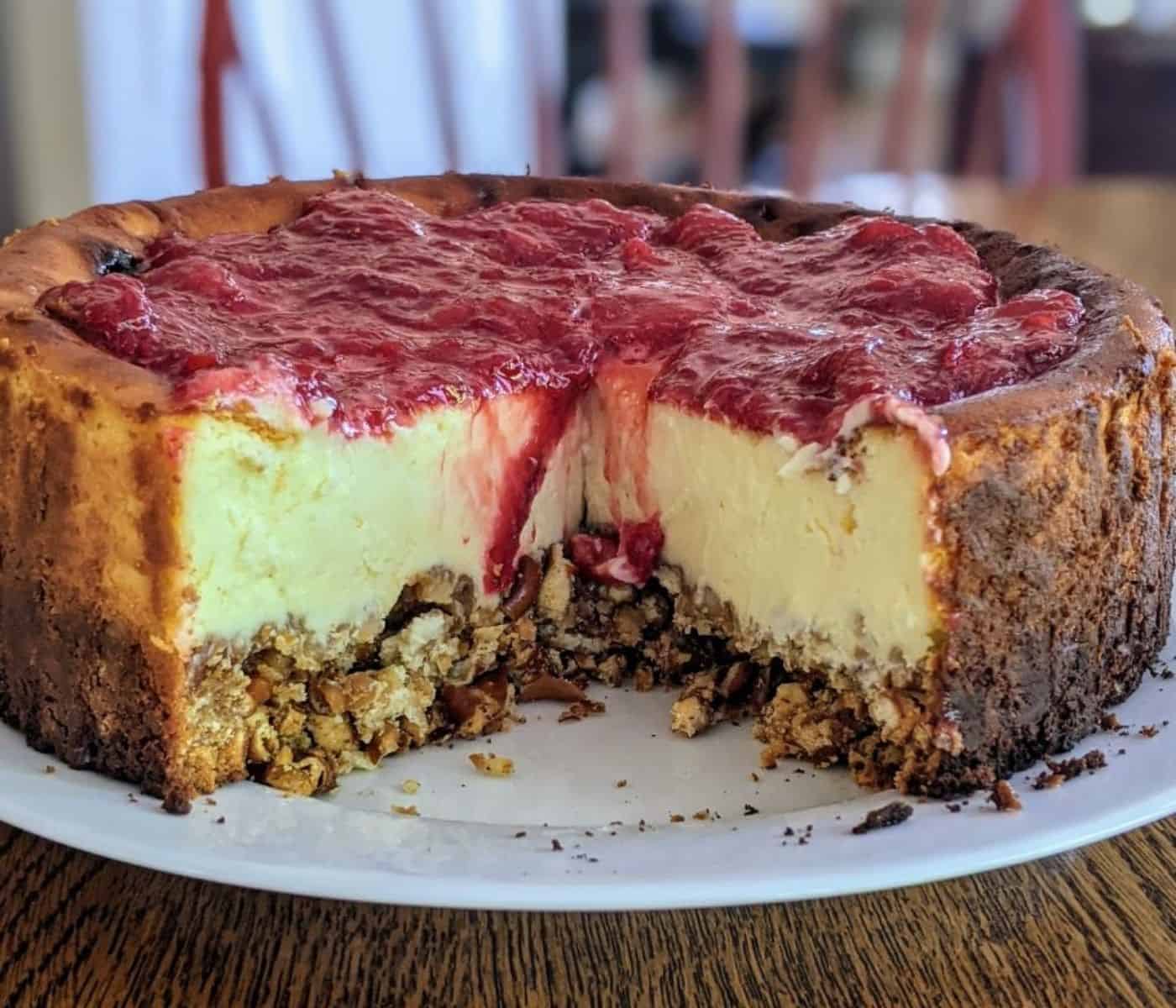 strawberry cheesecake with a pretzel crust on plate.