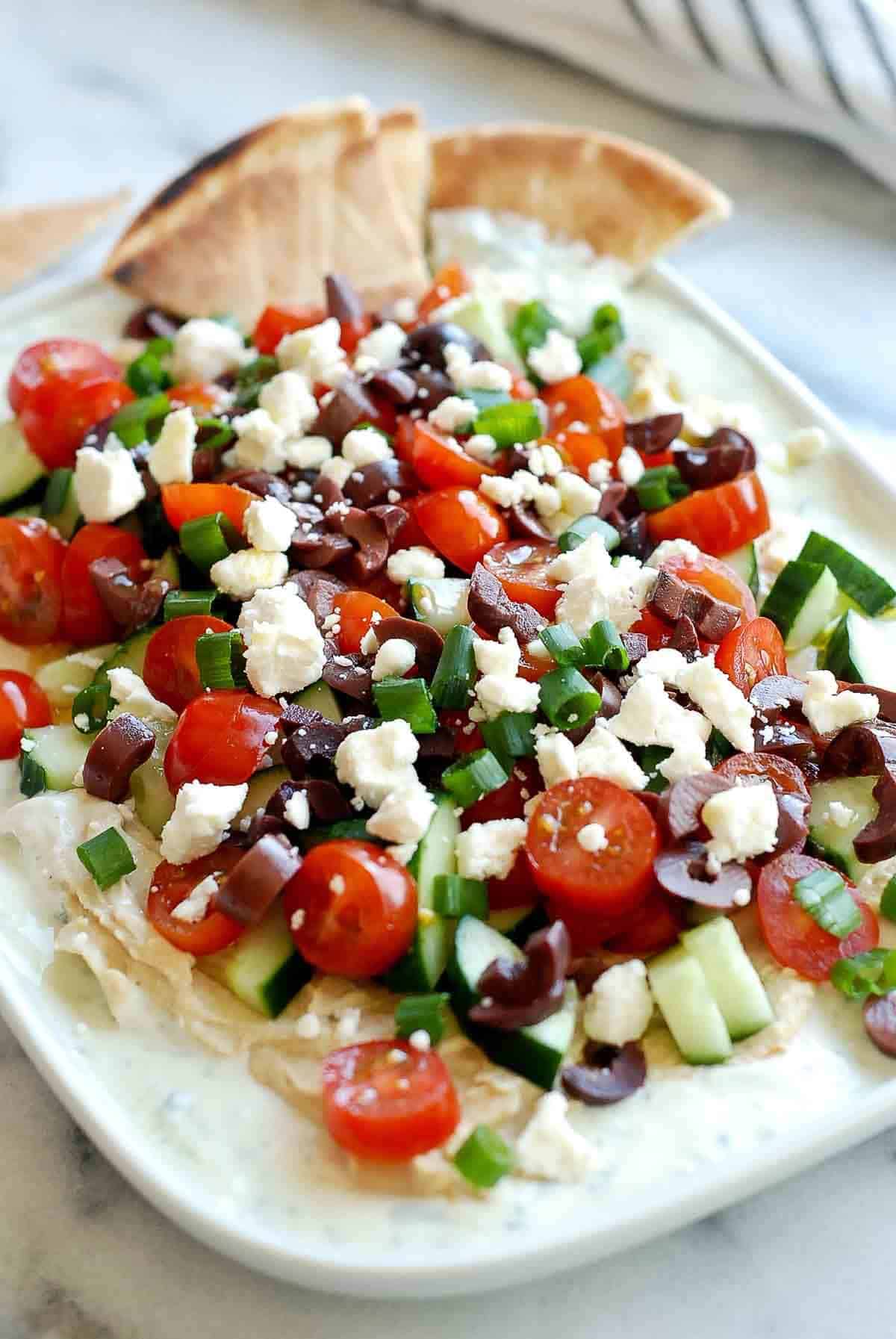 close up of 7 layer greek dip on platter.