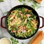 lemon salmon pasta in pot on cutting board.