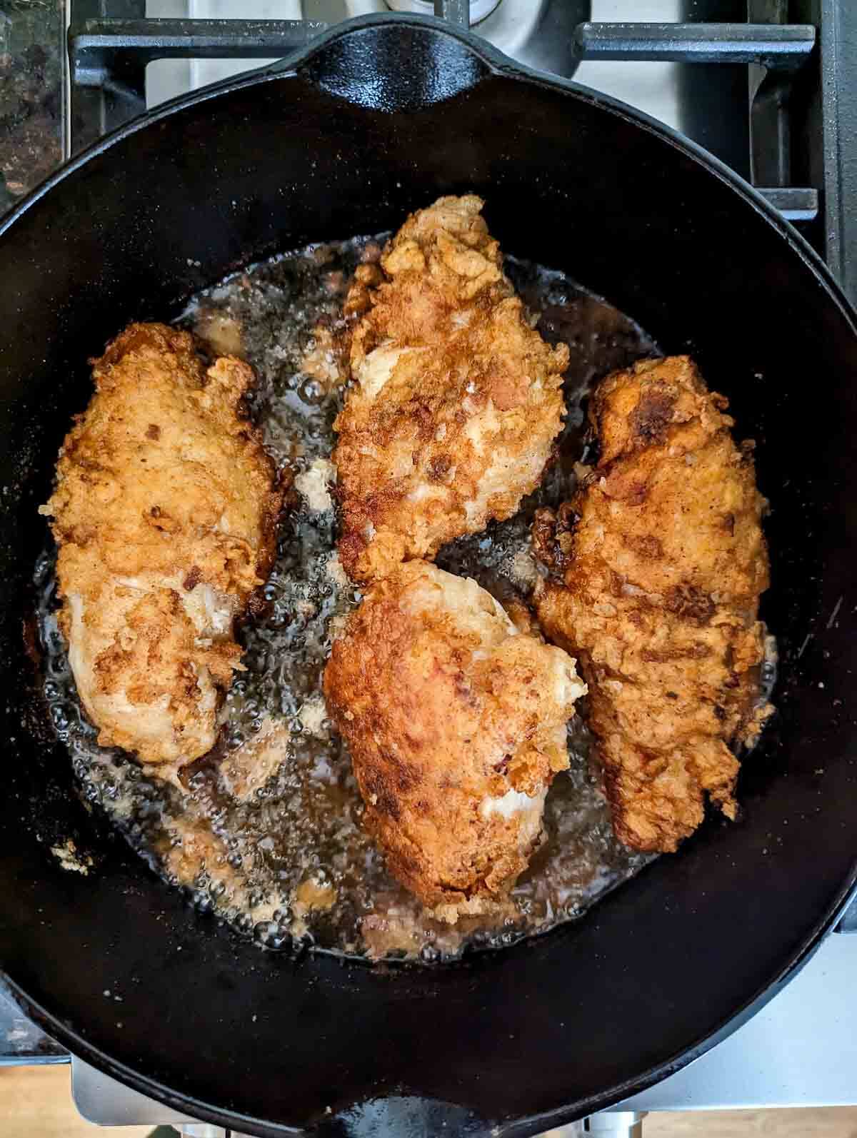 chicken frying in pan.
