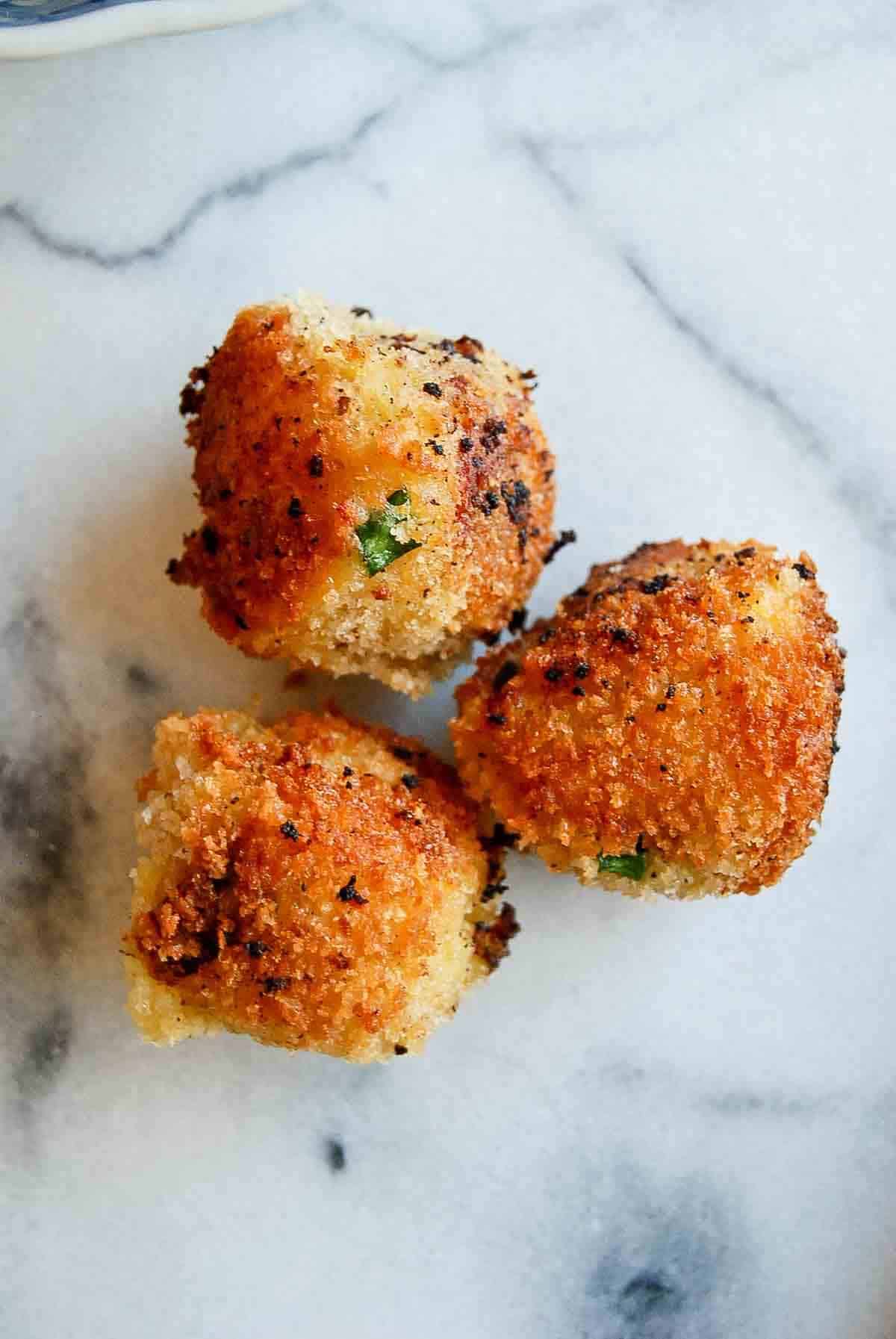 3 loaded mashed potato balls on counter