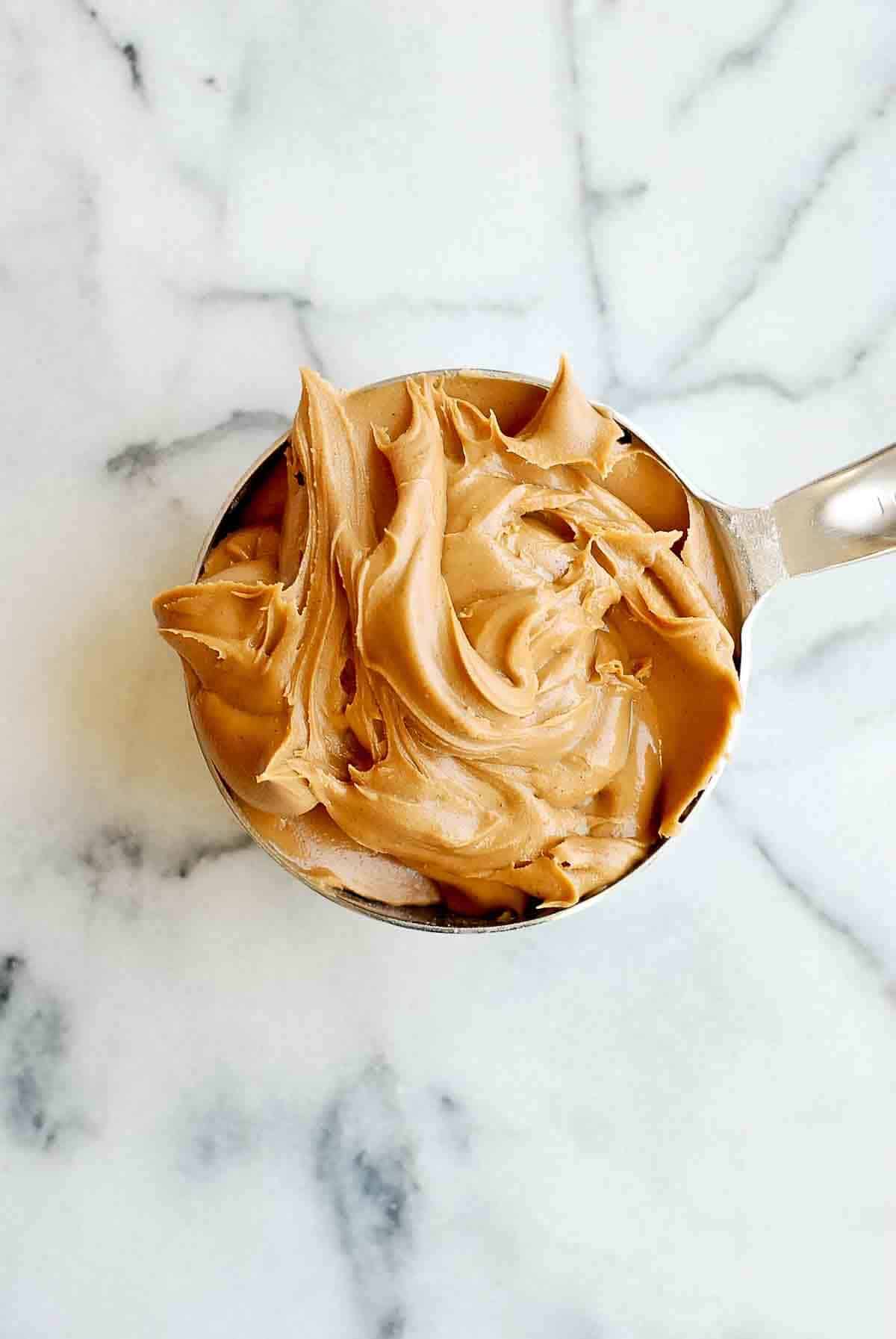 cup of peanut butter in measuring cup.