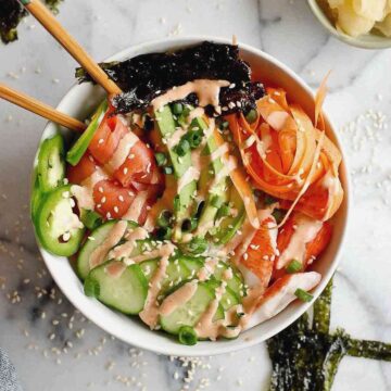 closeup of smoked salmon sushi bowl with chopsticks.