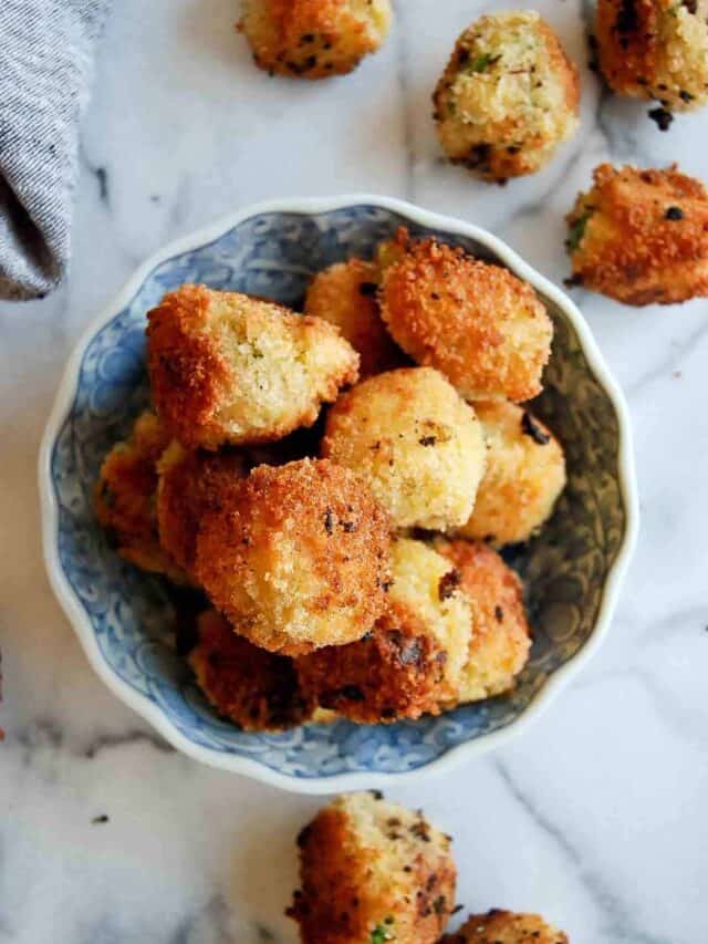 top down view of cheesy mashed potato balls in bowl.